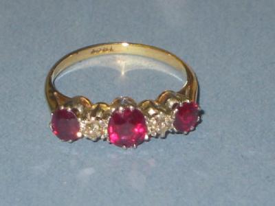 Appraisal: A RUBY AND DIAMOND RING comprising three oval cut rubies