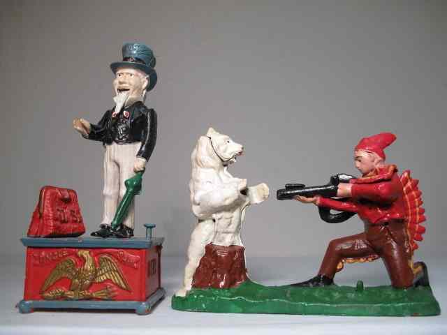 Appraisal: Vintage iron mechanical animated coin banks Includes a hunter dressed