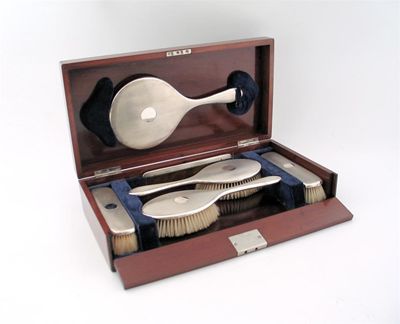 Appraisal: A modern six-piece engine turned dressing set in a fitted