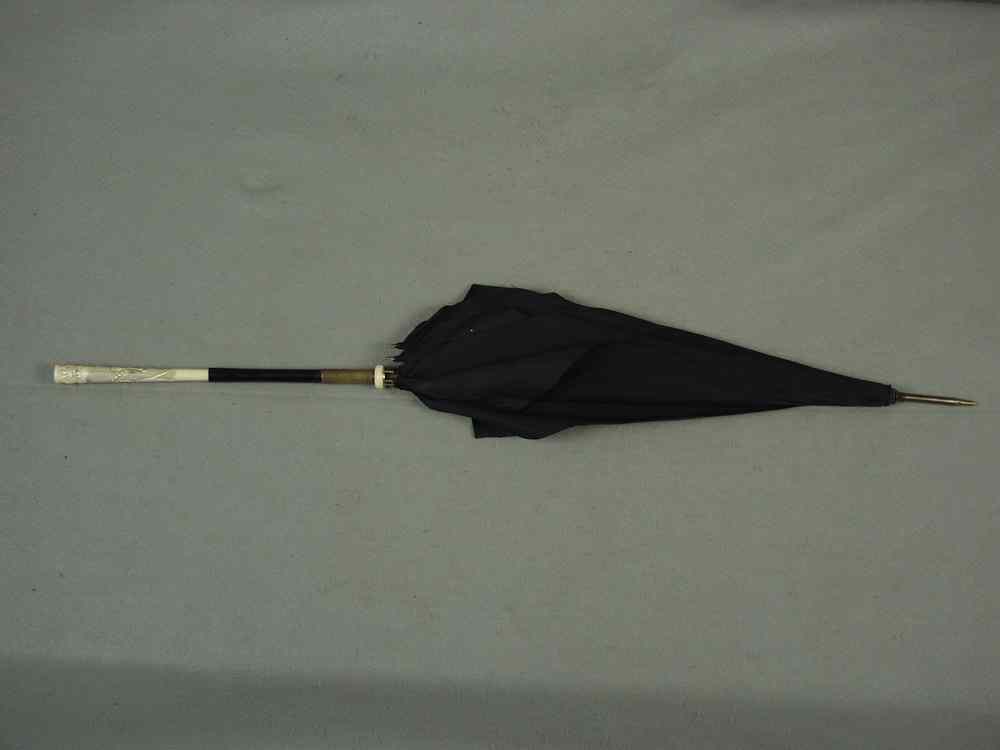 Appraisal: PARASOL - Carved ivory handle ebony shaft parasol brass fitted