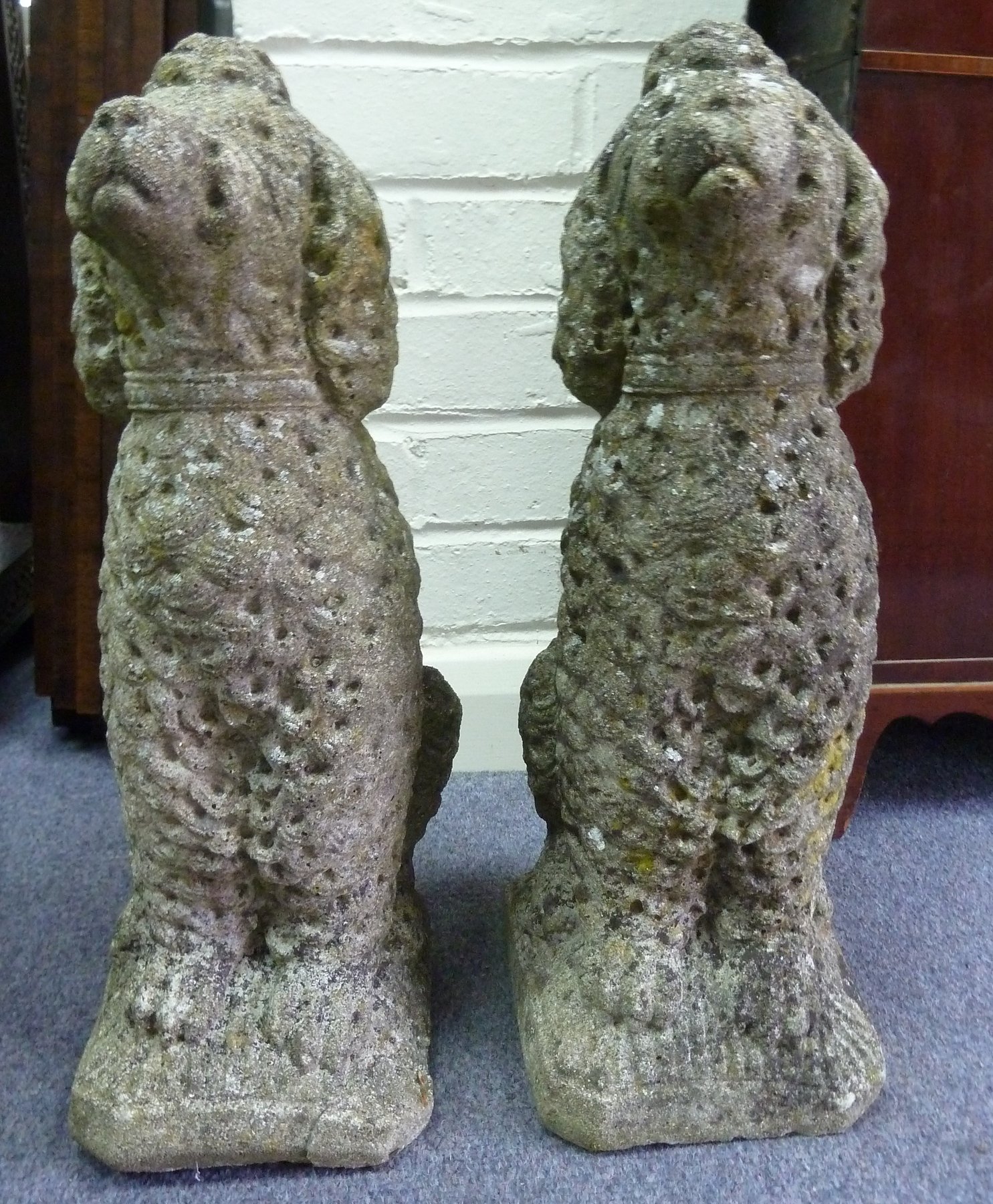 Appraisal: A pair of reconstituted stone poodles cm high