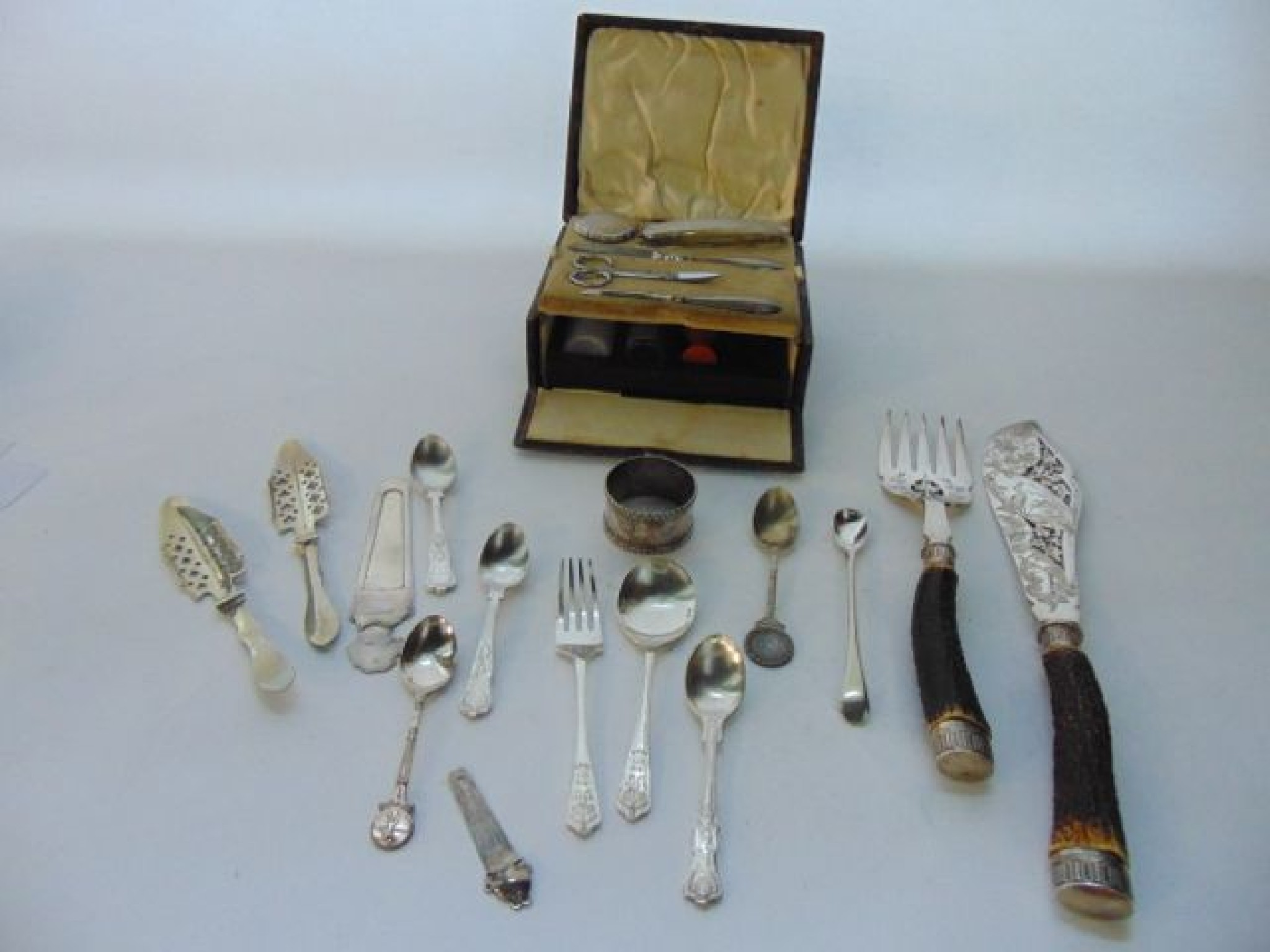 Appraisal: A cased George V silver manicure set Birmingham fitted below