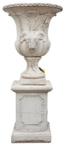 Appraisal: Large cast stone urn on base with ram's head handles