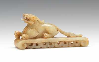 Appraisal: Carved Jade Recumbent Lion on Stand A carved light green