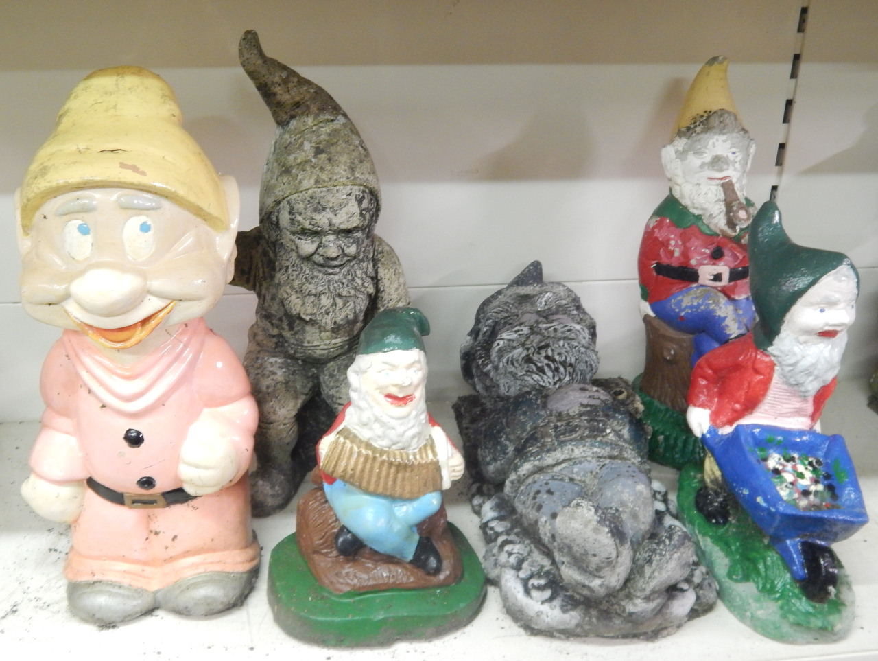 Appraisal: A collection of painted garden gnomes to include seated figures