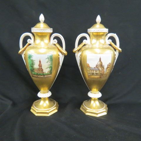 Appraisal: Pair of Dresden Handpainted Porcelain Urns city scapes elaborate gold