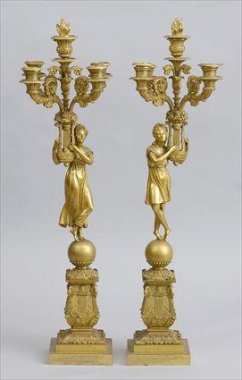 Appraisal: PAIR OF RESTAURATION GILT-BRONZE FOUR-LIGHT FIGURAL CANDELABRA Modeled as Apollo