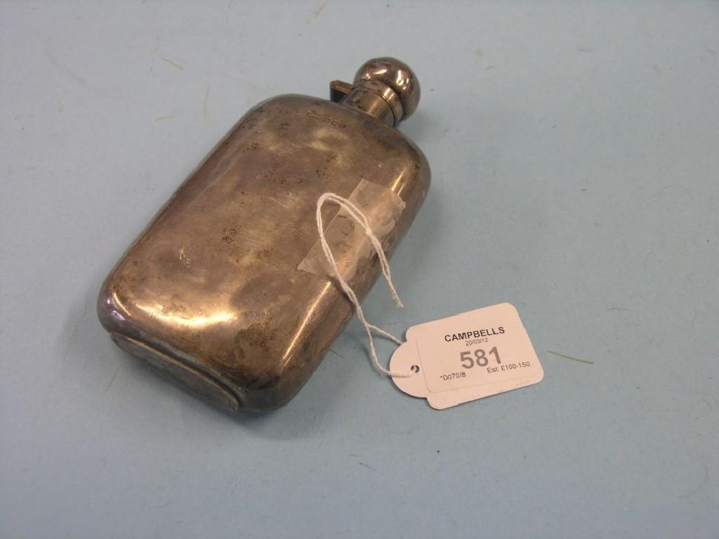 Appraisal: A silver hip flask with integral hinged cover Sheffield approx