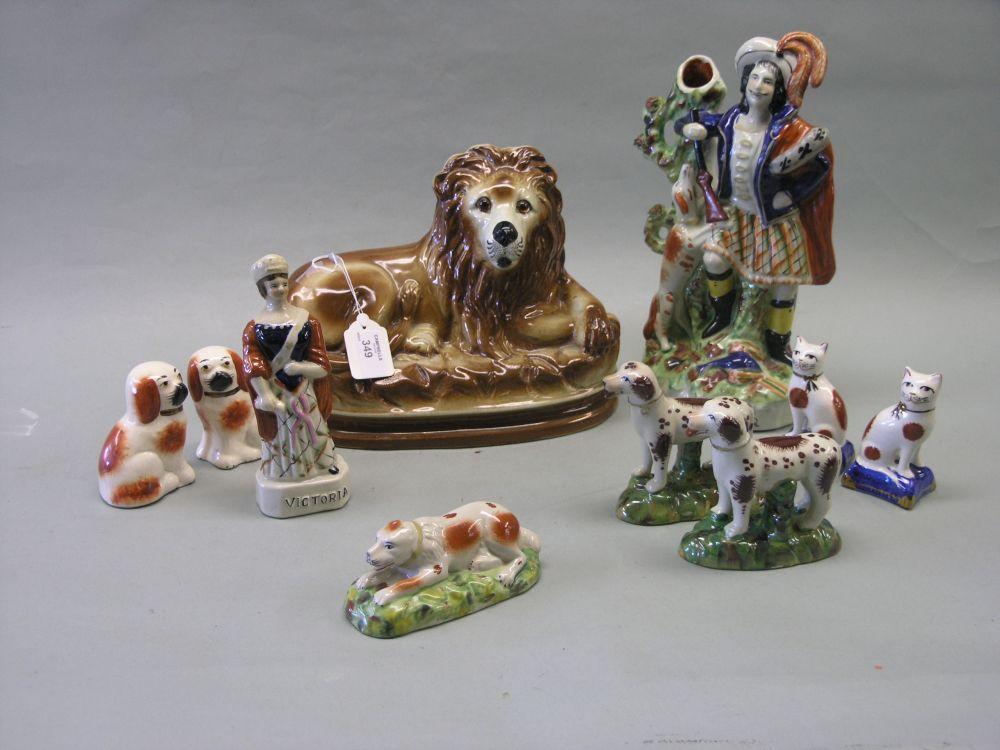 Appraisal: A reproduction Staffordshire figure entitled 'Highlander' together with two pairs