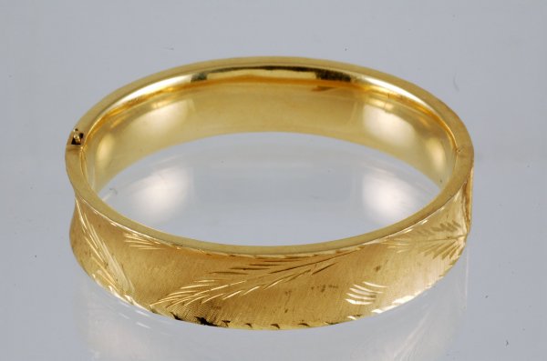 Appraisal: Yellow gold bangle bracelet Marked K Florentine finish to convex