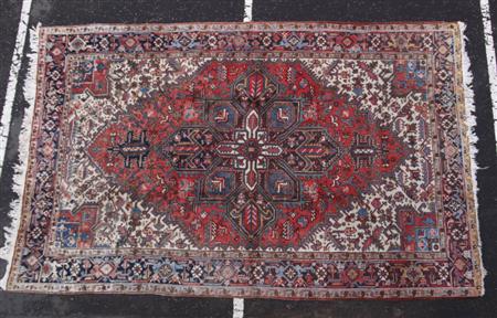 Appraisal: A Heriz carpet modern the red field with indigo and