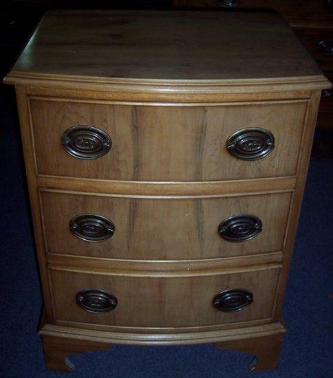 Appraisal: A small yew wood chest fitted three drawers on bracket