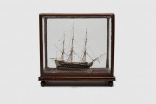 Appraisal: French Prisoner FRENCH PRISONER-OF-WAR CARVED BONE SHIP MODEL in glass