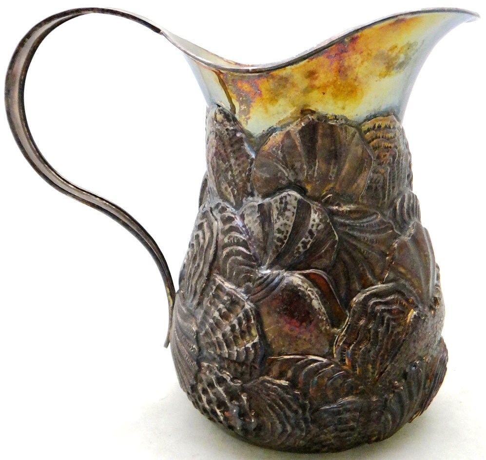 Appraisal: An Italian jug the body embossed with a variety of