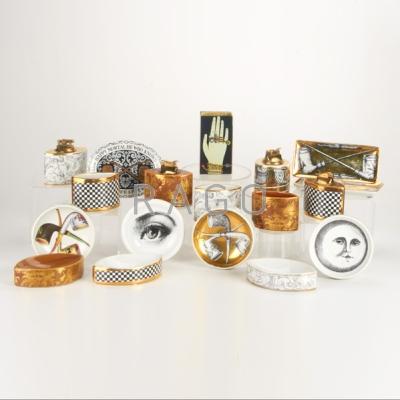 Appraisal: PIERO FORNASETTI Eighteen smoking accessories including lighters match holders etc