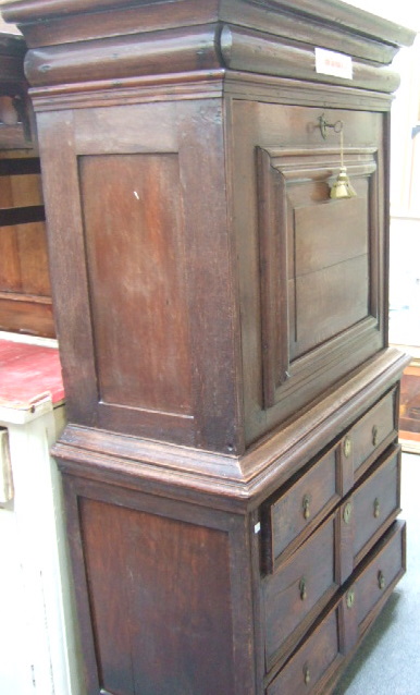 Appraisal: An early th century oak secretaire on chest the moulded