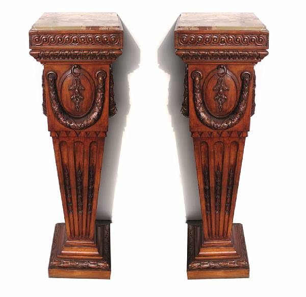 Appraisal: A pair of George III style carved fruitwood pedestals with