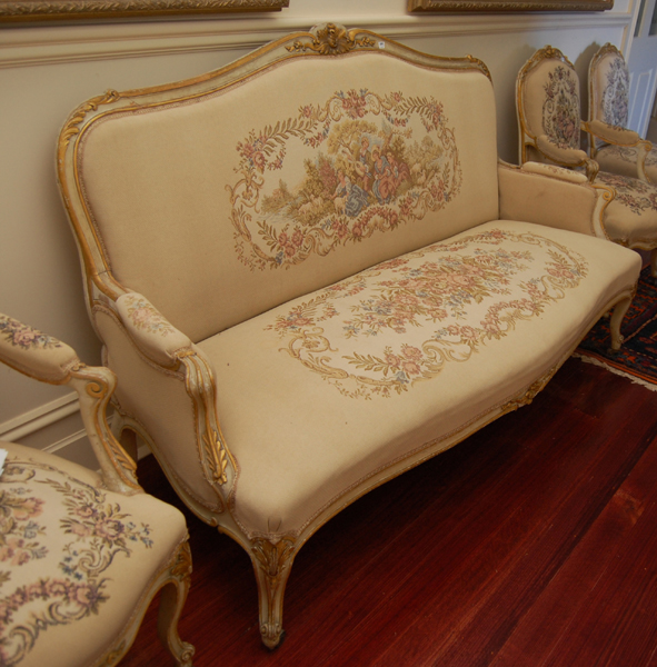 Appraisal: A LOUIS XV STYLE POLYCHROME SETTEE The foliate carved crest