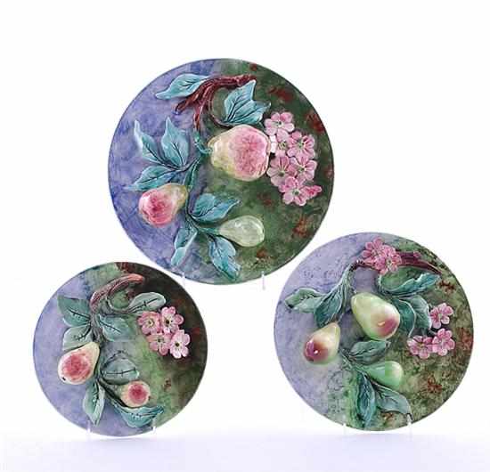 Appraisal: Longchamp barbotine tromp-l'oeil wall plaques circa round plaque with cast