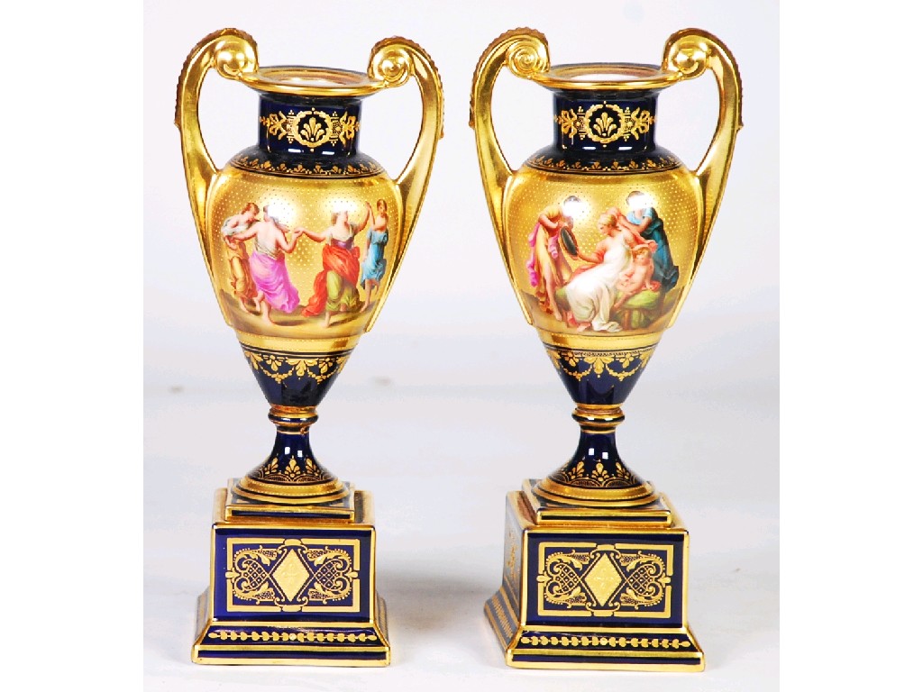 Appraisal: PAIR OF HAND PAINTED 'VIENNA' TWO HANDLED PORCELAIN VASES by