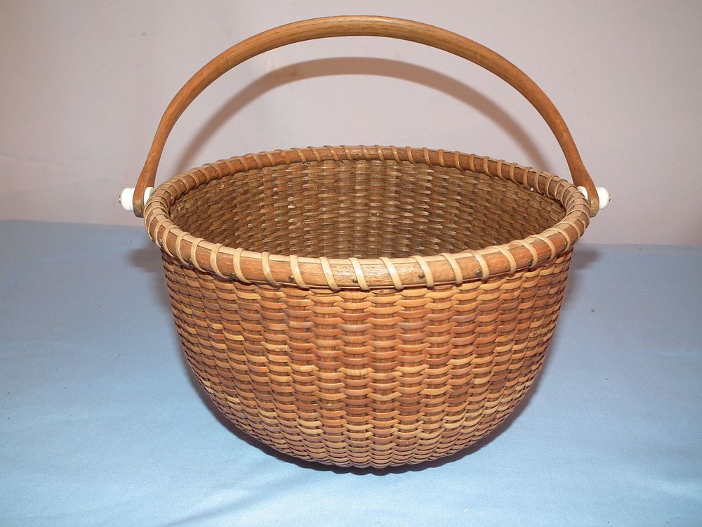 Appraisal: NANTUCKET BASKET Old round Nantucket basket unsigned x inches