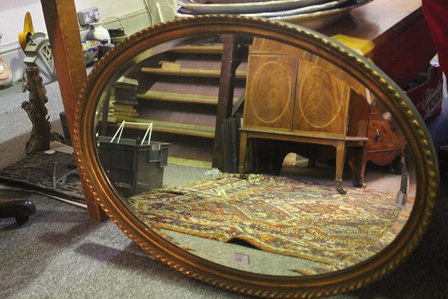 Appraisal: A VICTORIAN GILT OVAL WALL MIRROR with gadrooned frame and