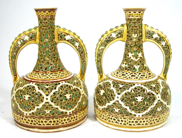 Appraisal: Pair of Zsolnay pierced pottery two handled vases enamelled with