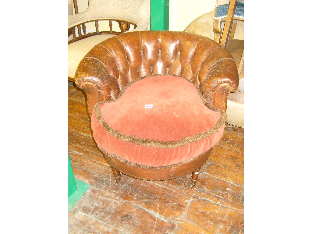 Appraisal: A Victorian tub chair with worn brown leather upholstered finish