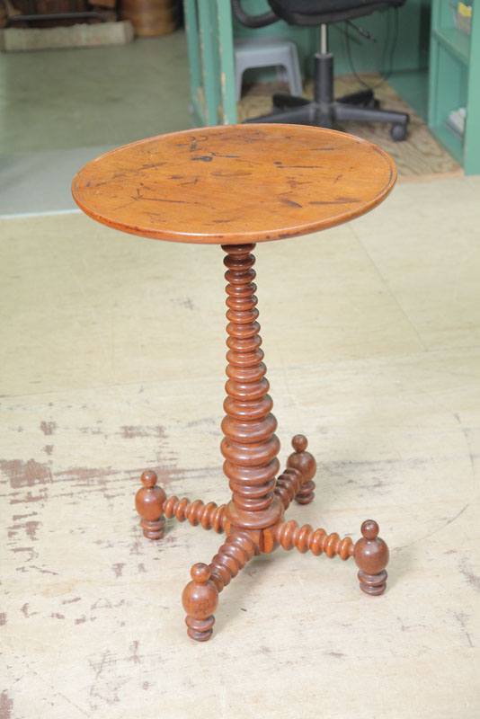 Appraisal: CANDLESTAND Walnut having a circular dish top resting on sausage