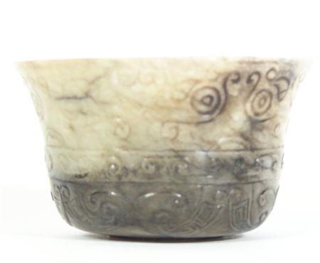 Appraisal: A Chinese pale and dark brown jade cup carved with