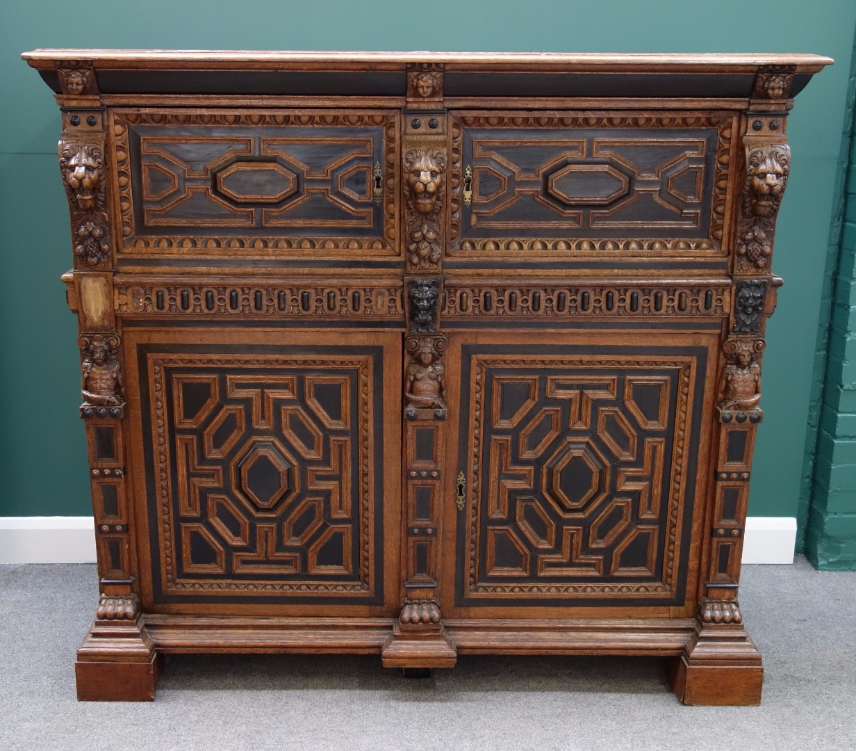 Appraisal: A th century oak and ebonised court cupboard with two