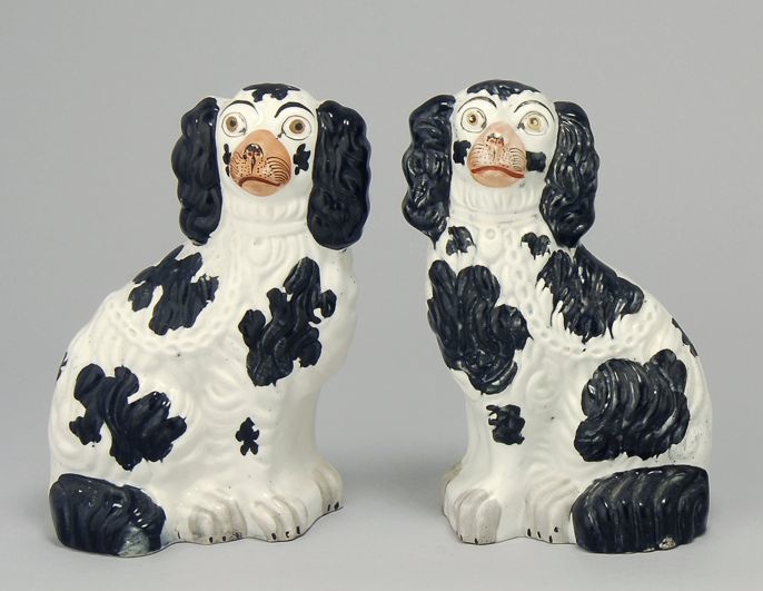 Appraisal: PAIR OF ENGLISH STAFFORDSHIRE POTTERY SPANIELS th CenturyIn black and