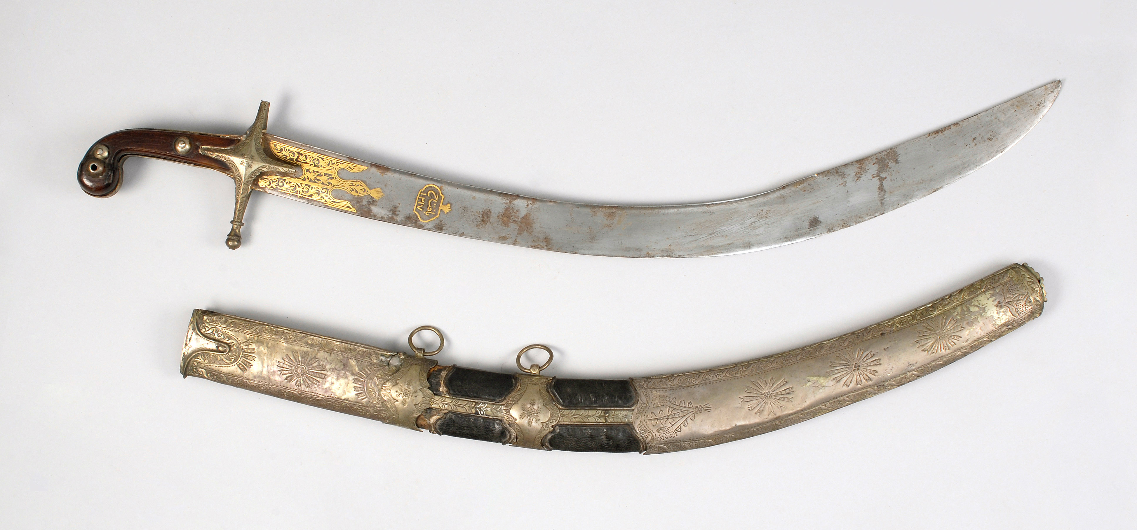 Appraisal: MIDDLE EASTERN SWORD Circa With metal-mounted leather scabbard brass-inlaid blade