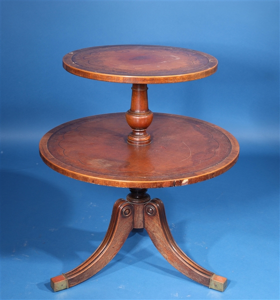 Appraisal: Two-tiered circular wooden table with gilt detail early th century