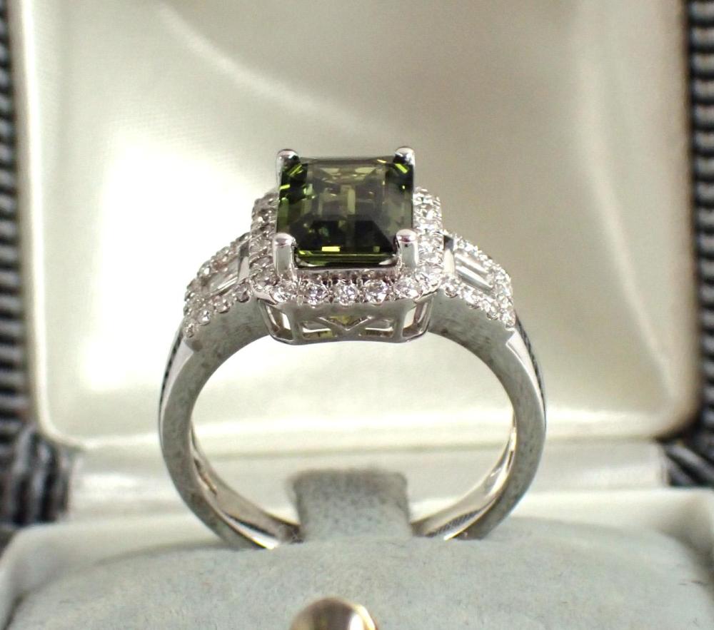 Appraisal: GREEN SAPPHIRE DIAMOND AND PLATINUM RING with round-cut diamonds and