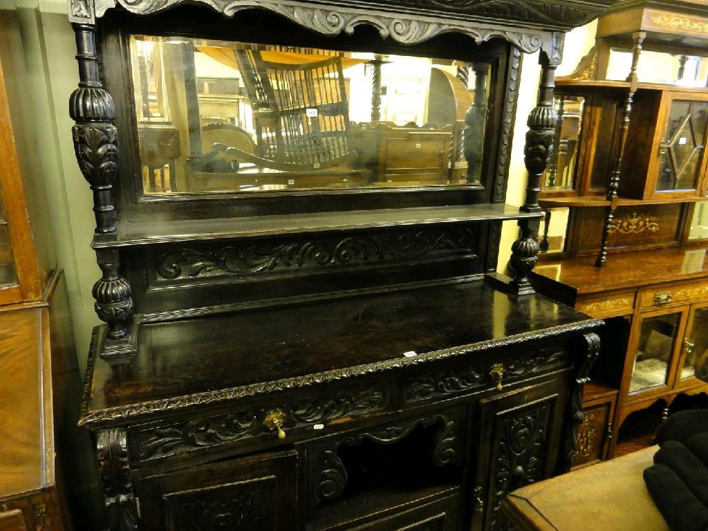 Appraisal: A Victorian dark oak sideboard the lower section fitted with