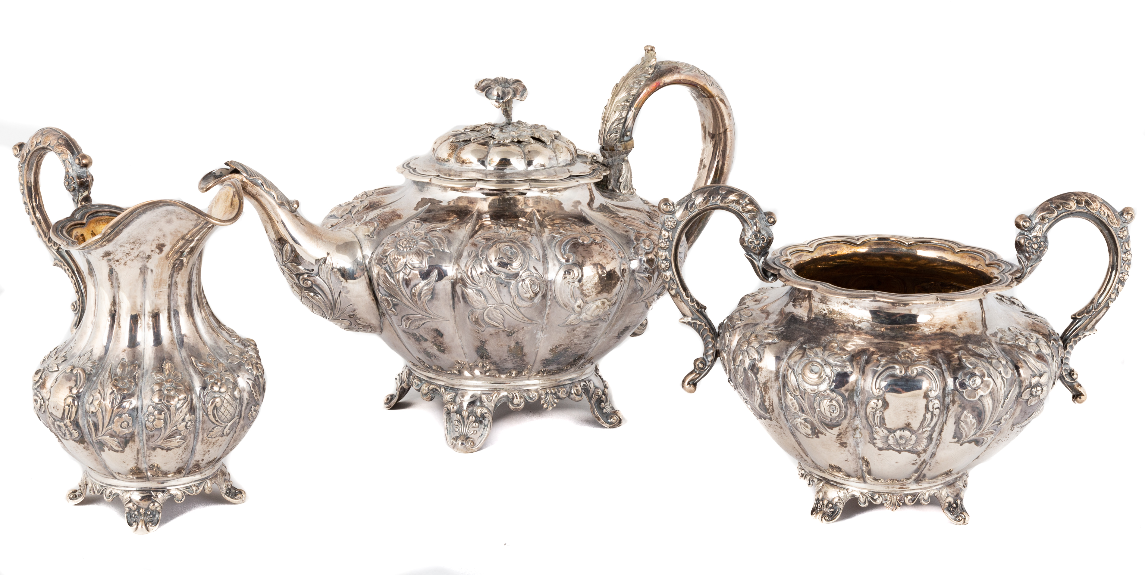 Appraisal: THREE PIECE ENGLISH SILVER TEA SET th century Hand chased