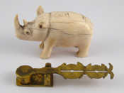 Appraisal: An ivory rhinoceros one ear damaged length cm together with