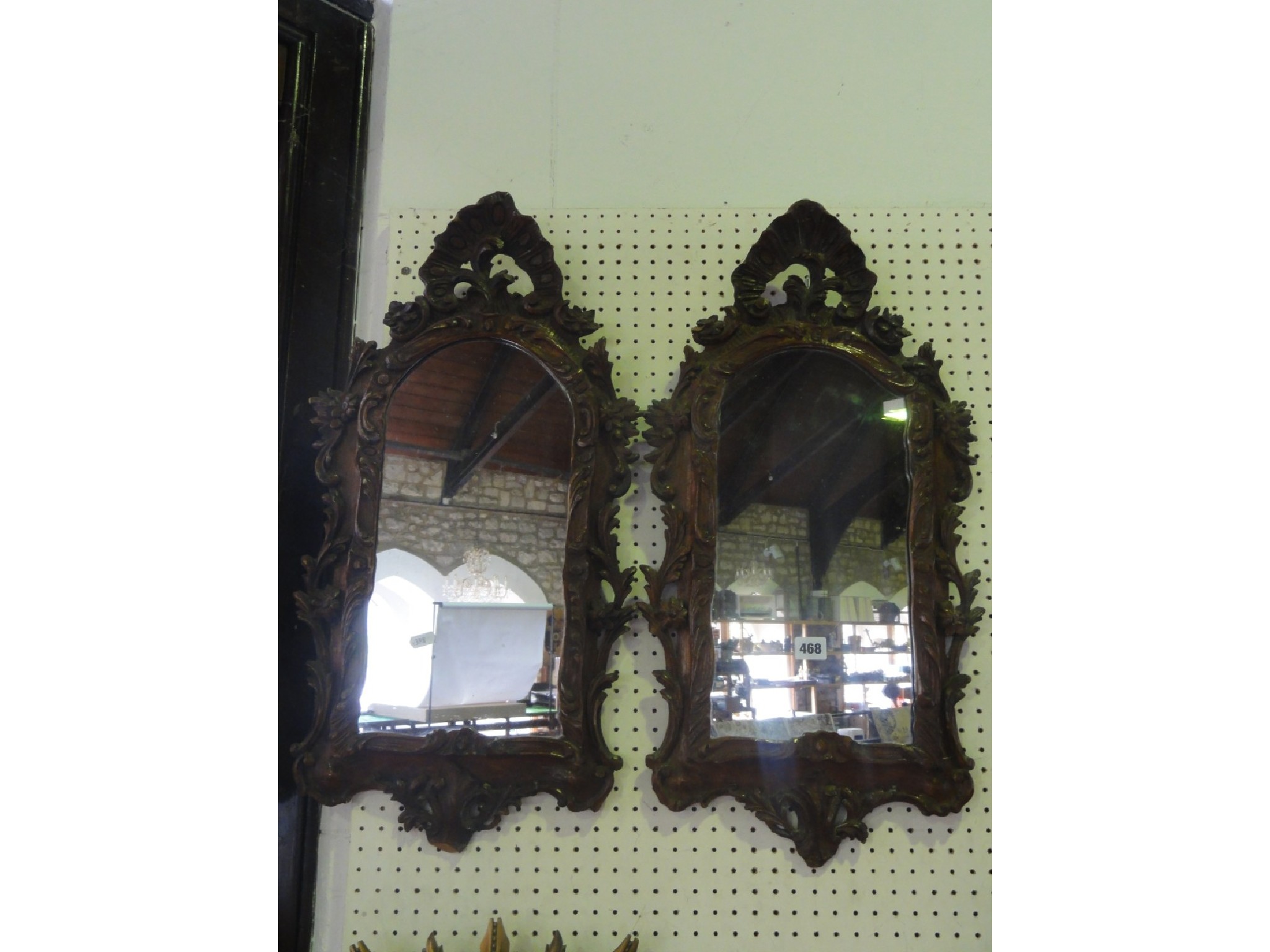 Appraisal: A pair of continental wall mirrors set within carved timber