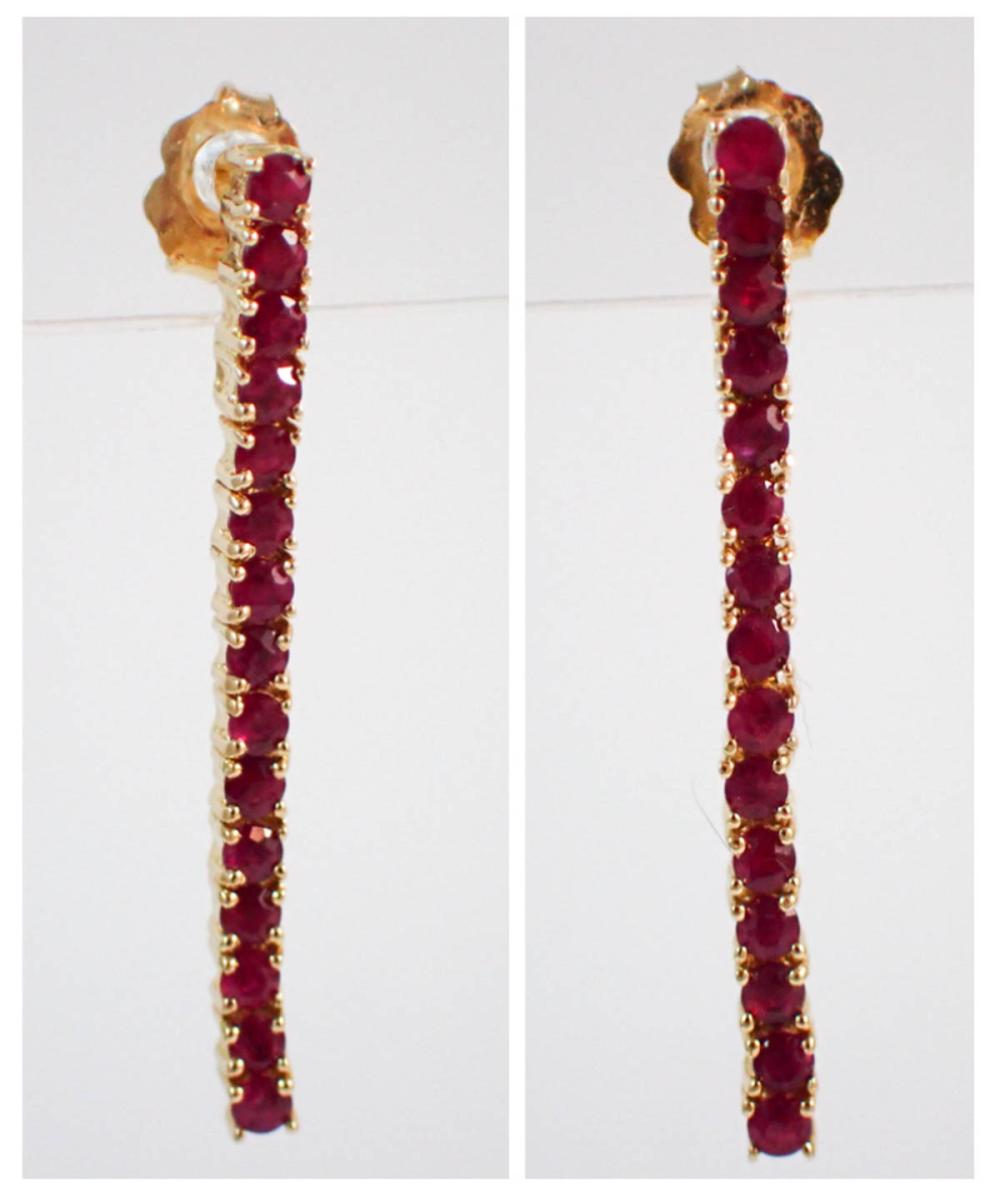 Appraisal: PAIR OF RUBY AND FOURTEEN KARAT GOLD DROP EARRINGS each