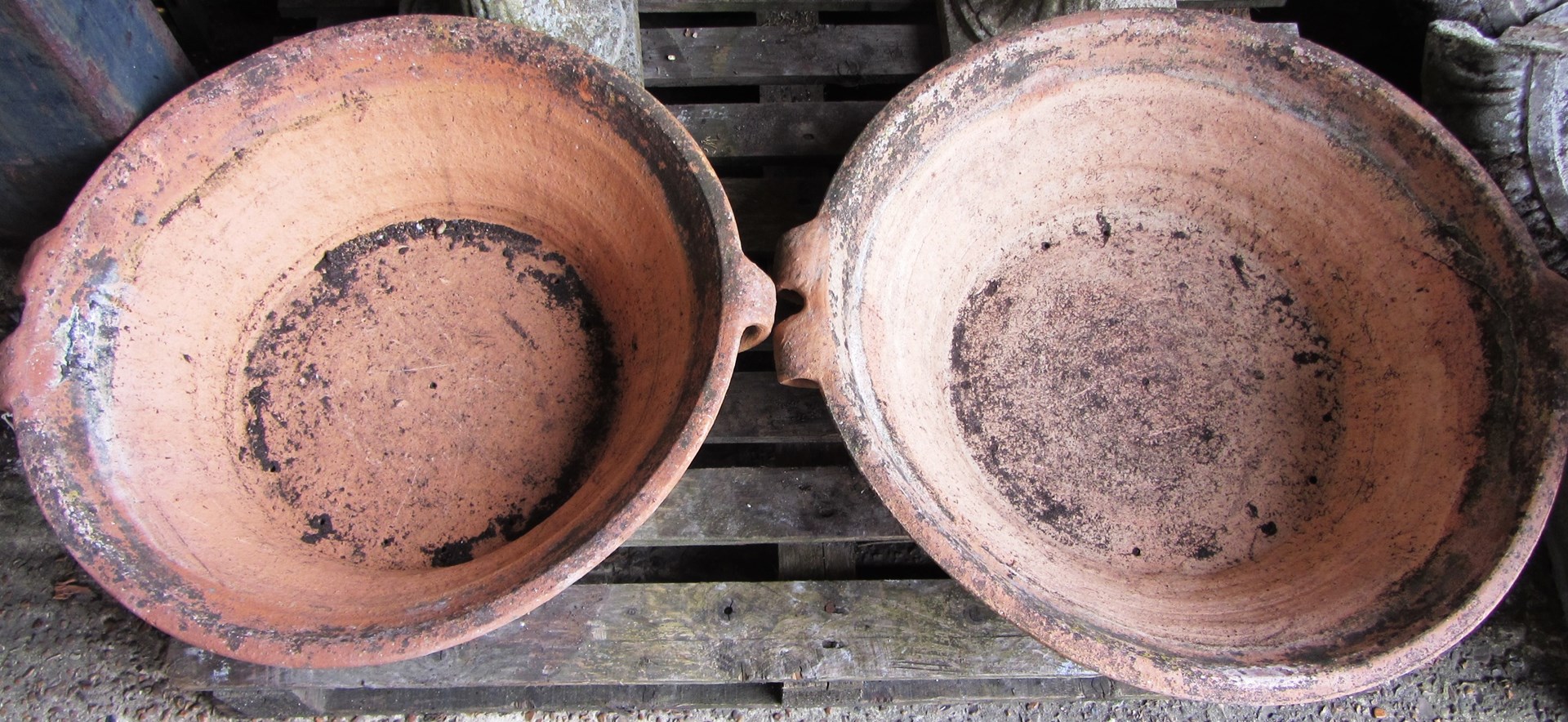 Appraisal: A pair of shallow terracotta circular pots each with double