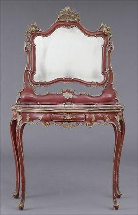 Appraisal: VENETIAN ROCOCO-STYLE CARVED AND RED-PAINTED DRESSING TABLE The cartouche-shape swing