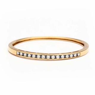 Appraisal: KT Diamond and Sapphire Bangle Bracelet the hinged bangle bracelet