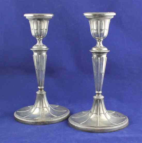 Appraisal: A pair of Edwardian silver candlesticks of oval form with