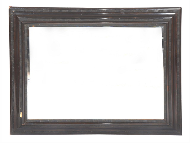 Appraisal: A LARGE RECTANGULAR HANGING WALL MIRROR in carved cushion frame