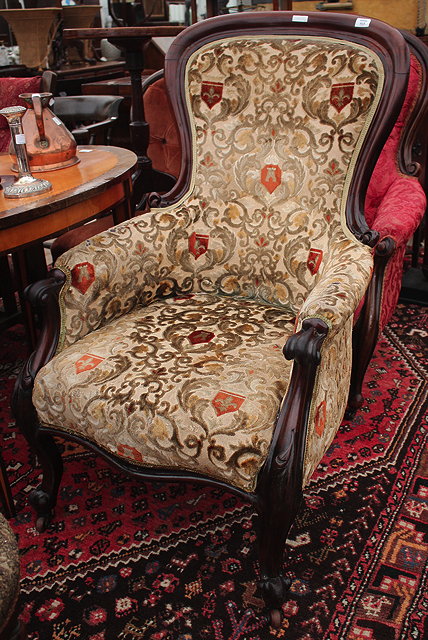 Appraisal: A VICTORIAN MAHOGANY FRAMED LIBRARY ARMCHAIR with overstuffed upholstered serpentine