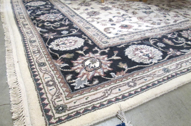 Appraisal: HAND KNOTTED ORIENTAL CARPET Indo-Persian Isfahan floral design on cream