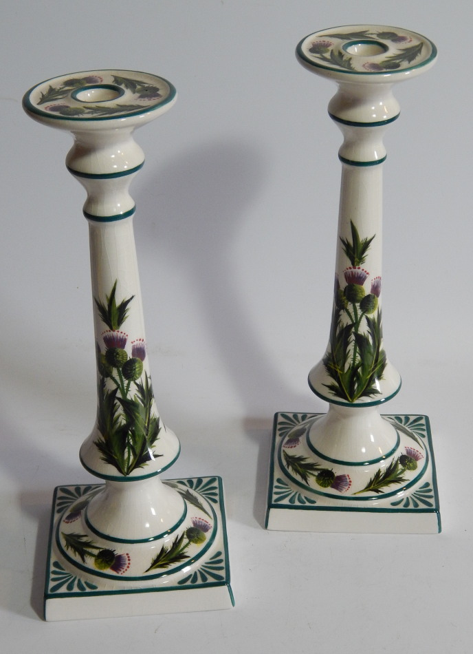 Appraisal: A pair of thC Griselda Hill pottery Wemyss style candlesticks