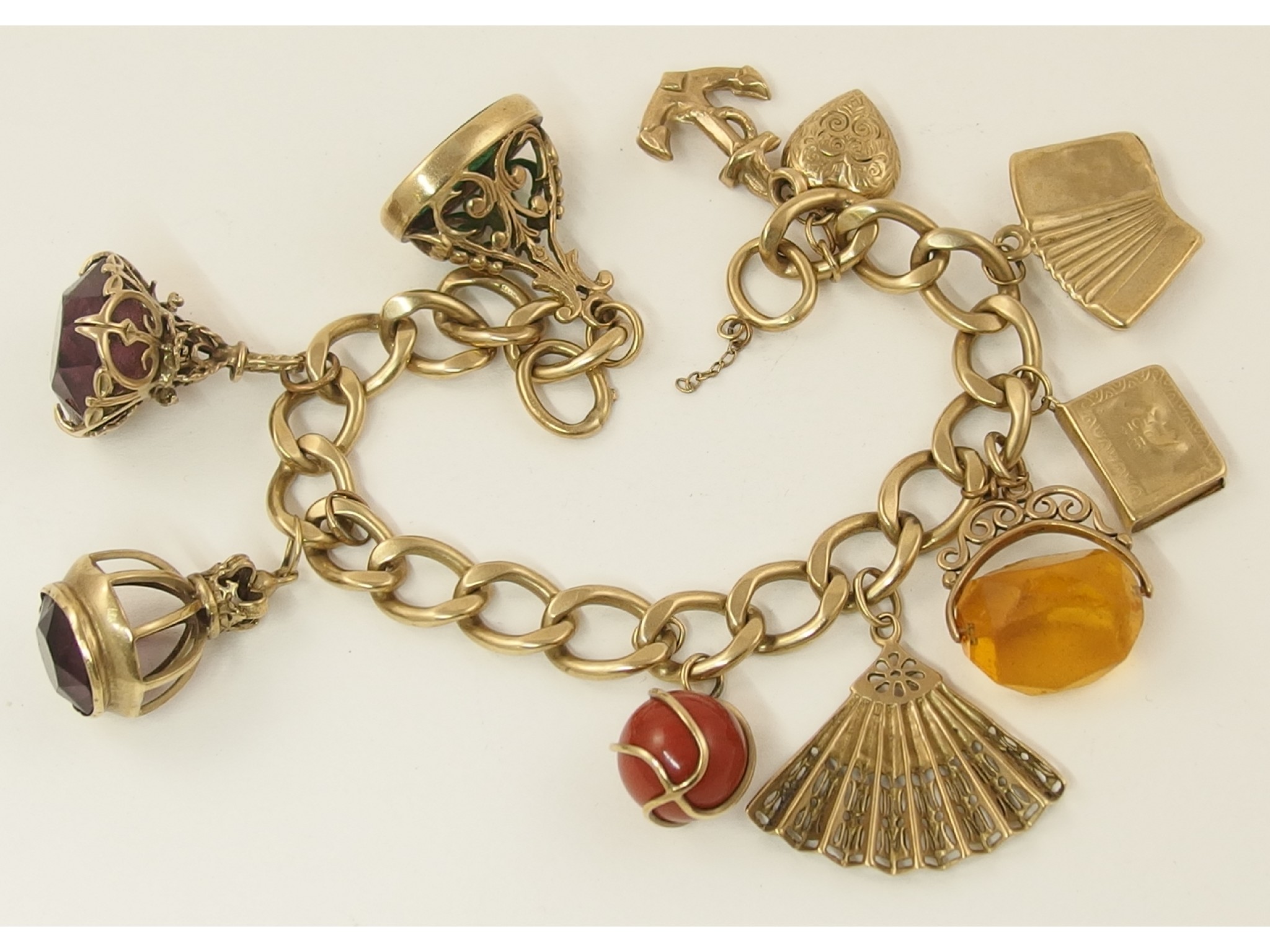 Appraisal: A ct charm bracelet with ten attached charms in ct