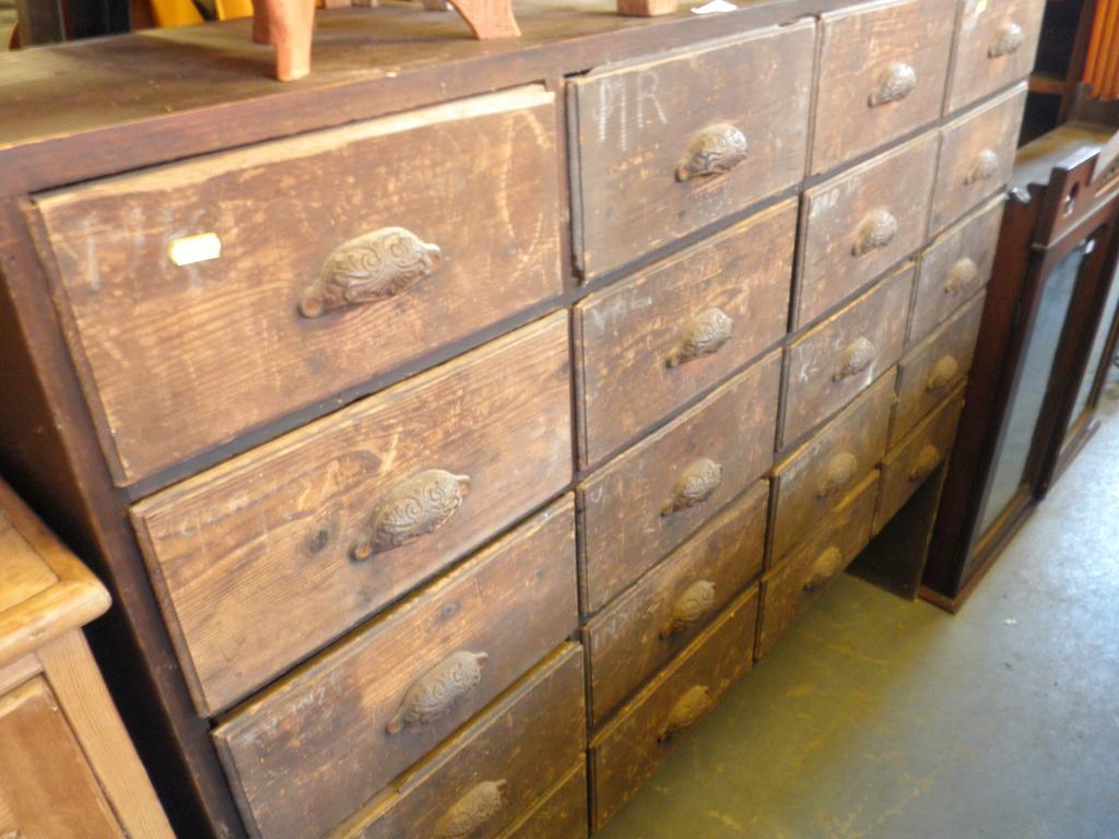 Appraisal: A bank of twenty stained pine drawers